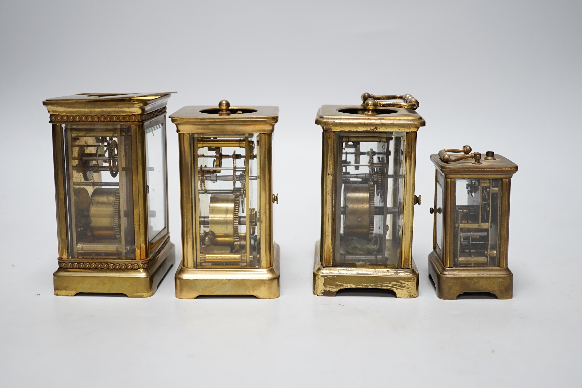 Four carriage clocks in varying sizes, tallest 12cm high